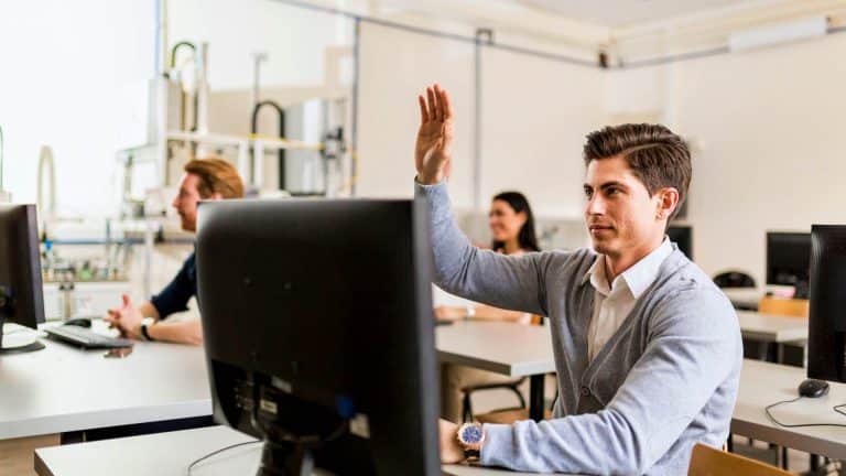 A guy with his hand up on the IQA Course.