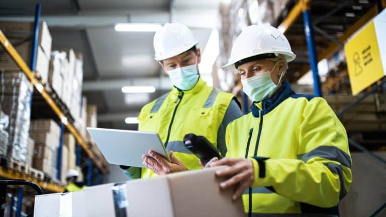 A man and woman wearing safety clothing as part of the Highfield level 2 award in health and safety.