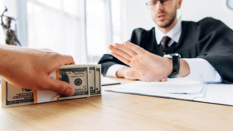 A man confidently refuses a cash bribe after completing the Highfield E-Learning Introduction to the Bribery Act 2010 Course.