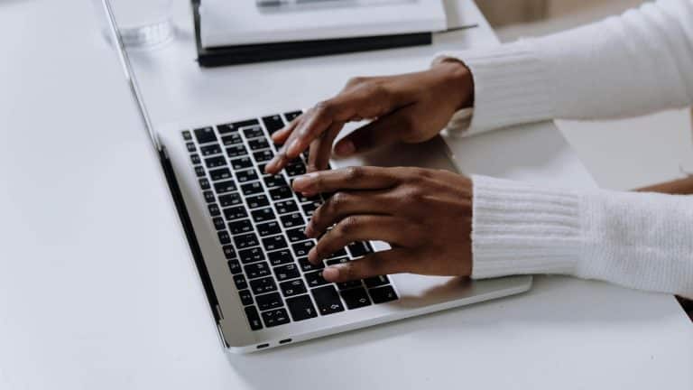 A person typing at a laptop realised she should take a break after completing the Highfield E-Learning Display Screen Equipment Course.