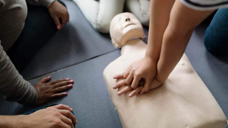 A trainer demonstrating emergency first aid as part of the FAA Award in Emergency First Aid at Work Course.